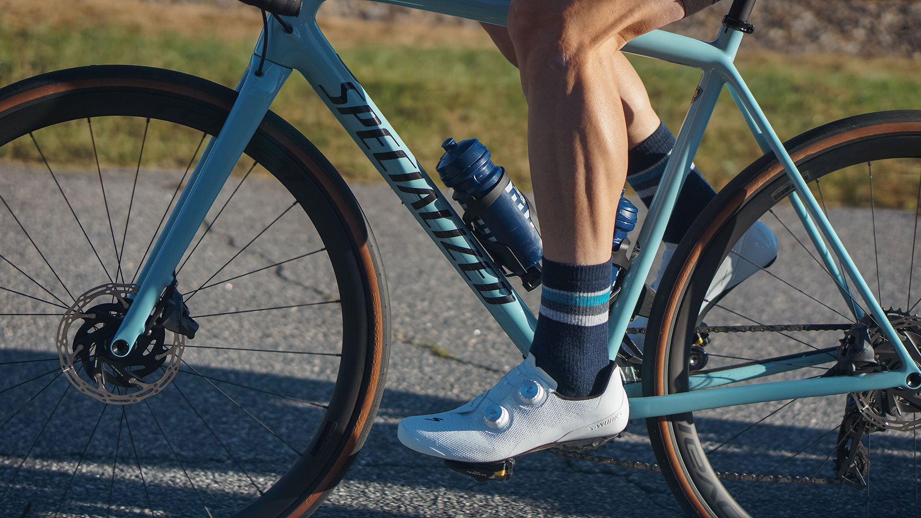 Cyclist on road bike wearing DeFeet Woolie Boolie cushioned wool cycling and all purpose socks